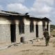A member of Kenyas security forces walks past a damaged police post after an attack by al Shabab in the settlement of Kamuthe in Garissa county Kenya on January 13 2020