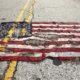 A partially burned American flag lies on the street near the spot where Michael Brown was killed in Ferguson Missouri August 9 2015