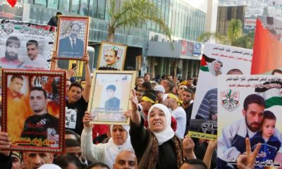 Palestinians hold pictures of relatives held in Israeli jails during a rally marking Palestinian Prisoner Day in the West Bank city of Nablus on April 16 2017
