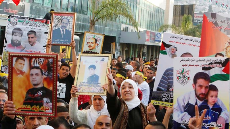 Palestinians hold pictures of relatives held in Israeli jails during a rally marking Palestinian Prisoner Day in the West Bank city of Nablus on April 16 2017