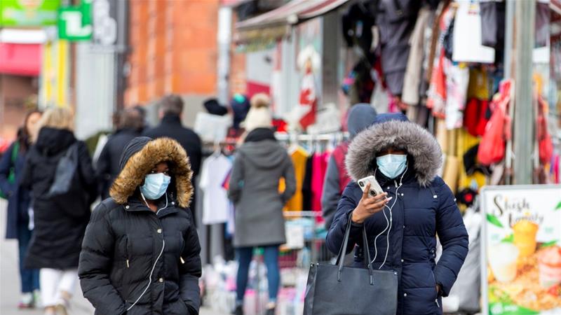 Pedestrians walk in the Chinatown district of downtown Toronto Ontario on January 28 2020. Three patients with novel coronavirus have been reported in Canada