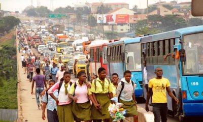 Pupils and other stranded commuters trekking at Ojota Long Bridge on Ikorodu Road Lagos