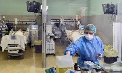 A medical worker treats patients suffering from COVID-19 in an intensive care unit at the Oglio Po hospital in Cremona, Italy on March 19, 2020 [File: Flavio Lo Scalzo/Reuters]