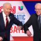 Joe Biden and Bernie Sanders do an elbow bump in place of a handshake before the start of the 11th Democratic candidates debate in Washington DC