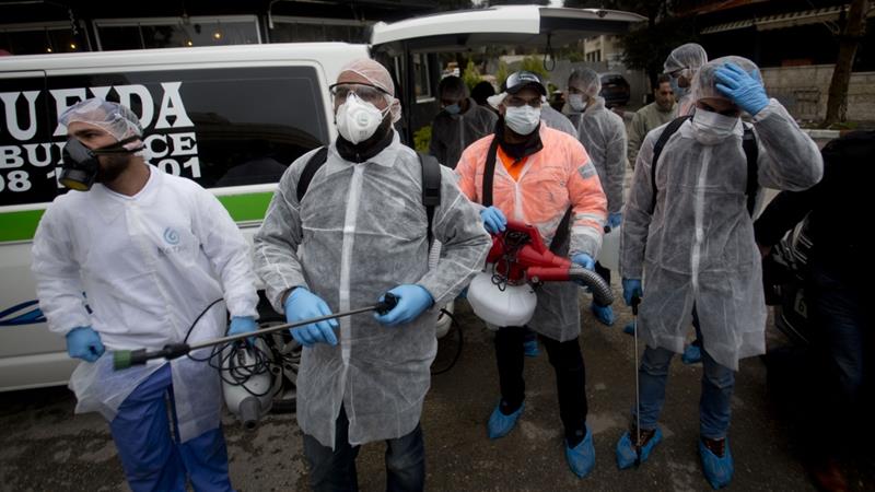 Palestinian workers get ready to disinfect mosques and churches as a preventive measure against the coronavirus in Ramallah in the occupied West Bank on March 7 2020