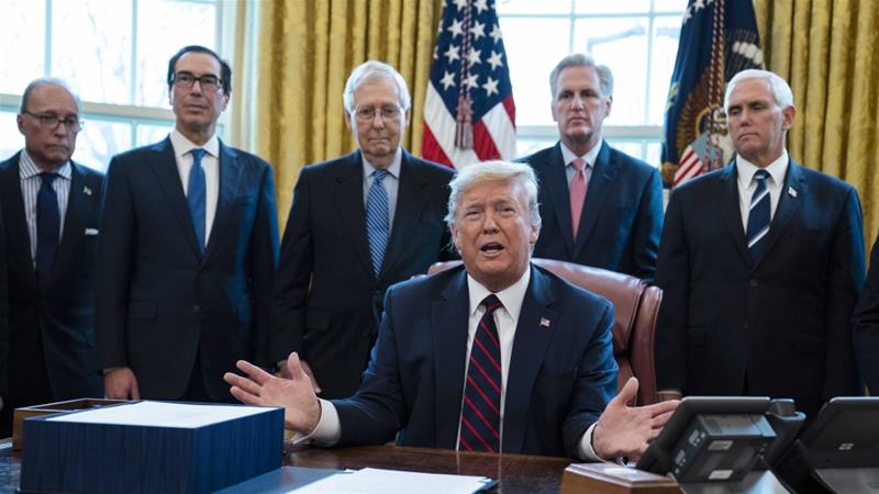 President Donald Trump talks to reporters before signing the coronavirus stimulus relief package in the Oval Office at the White House on March 27 2020