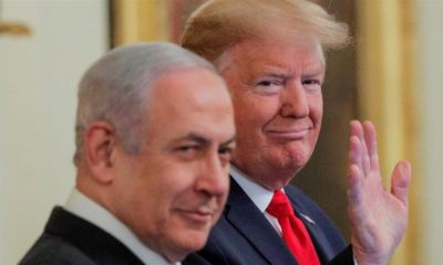 US President Donald Trump waves next to Israeli Prime Minister Benjamin Netanyahu prior to presenting his Middle East plan at the White House on January 28 2020