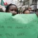 A migrant domestic worker holds up a placard during a parade in advance of May Day in Beirut on April 29 2012 1