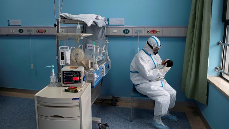 A nurse in a protective suit attends to a baby with COVID 19 at an isolation ward of Wuhan Childrens Hospital in Wuhan Hubei province China on March 16 2020