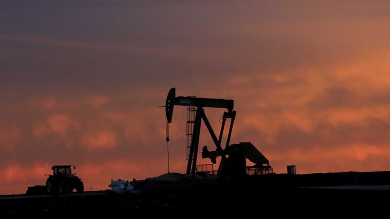 A well pump works at sunset on a farm near Sweetwater Texas on December 22 2014