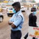 Kenyan police officers check vehicles at a roadblock to control traffic coming into Nairobi during a partial lockdown on April 7 2020