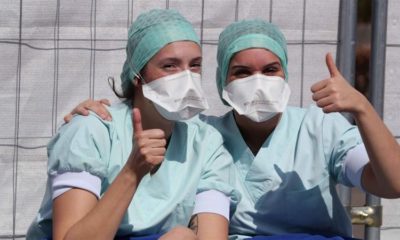 Members of the medical personnel gesture in the testing site for coronavirus disease COVID 19 at CHU de Liege hospital in Liege Belgium on April 4 2020