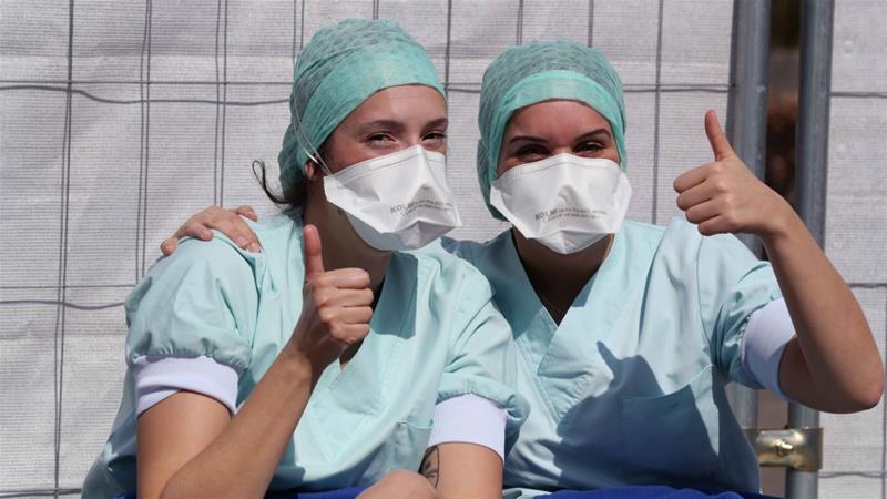 Members of the medical personnel gesture in the testing site for coronavirus disease COVID 19 at CHU de Liege hospital in Liege Belgium on April 4 2020