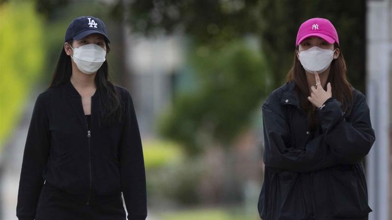 Pedestrians wears face masks in the Chinatown neighbourhood of Los Angeles on April 2 2020 during the coronavirus outbreak