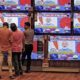 People watch Indian Prime Minister Narendra Modi address the nation amid concerns about the spread of coronavirus inside a showroom in Ahmedabad India on March 19 2020