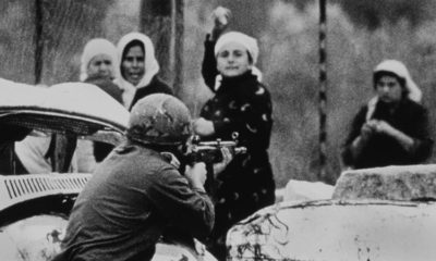 An Israeli soldier aims his rifle at a Palestinian woman holding a rock during a demonstration in which one Palestinian youth was shot dead in Gaza on February 29 1988