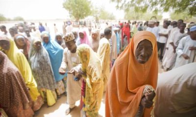 An elderly Nigerian woman stands in the shade while waiting to cast her vote at a polling station in Daura northern Nigeria on March 28 2015