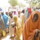 An elderly Nigerian woman stands in the shade while waiting to cast her vote at a polling station in Daura northern Nigeria on March 28 2015
