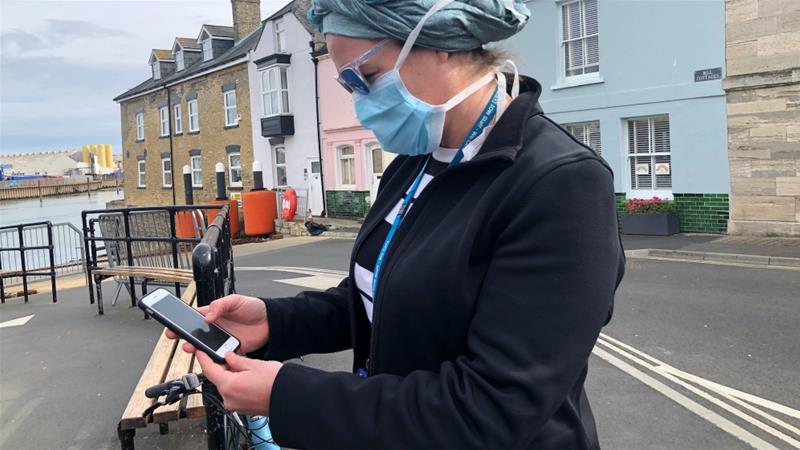 An employee of the UK National Health Service looks at the new NHS app to trace contacts with people potentially infected with COVID 19 Isle of WightUK May 5 2020