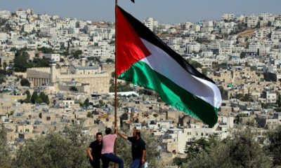 Demonstrators place a Palestinian flag during a protest against Israeli Prime Minister Benjamin Netanyahus visit to Hebron in the occupied West Bank September 4 2019