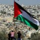 Demonstrators place a Palestinian flag during a protest against Israeli Prime Minister Benjamin Netanyahus visit to Hebron in the occupied West Bank September 4 2019