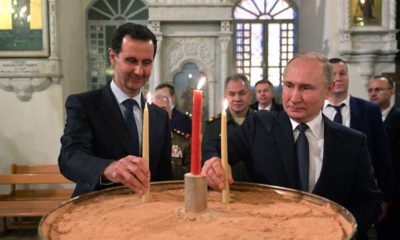 Russian President Vladimir Putin and his Syrian counterpart Bashar al Assad visit an Orthodox Christian church in Damascus Syria on January 7 2020