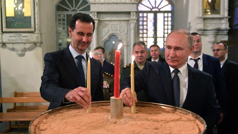 Russian President Vladimir Putin and his Syrian counterpart Bashar al Assad visit an Orthodox Christian church in Damascus Syria on January 7 2020