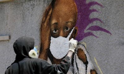 Serigne Zeus Boye a graffiti artist works on his mural to encourage people to protect themselves amid the COVID 19 outbreak in Dakar Senegal on March 25 2020