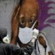 Serigne Zeus Boye a graffiti artist works on his mural to encourage people to protect themselves amid the COVID 19 outbreak in Dakar Senegal on March 25 2020