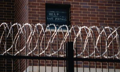 Signs made by prisoners pleading for help are seen on a window of Cook County Jail in Chicago Illinois US April 7 2020 amid the COVID 19 outbreak