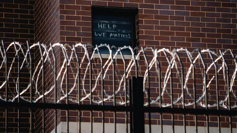 Signs made by prisoners pleading for help are seen on a window of Cook County Jail in Chicago Illinois US April 7 2020 amid the COVID 19 outbreak