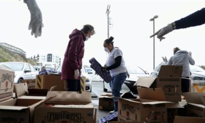 Volunteers sort apples at the San Francisco Marin Food Bank amid the novel coronavirus COVID 19 outbreak in San Francisco California US March 16 2020