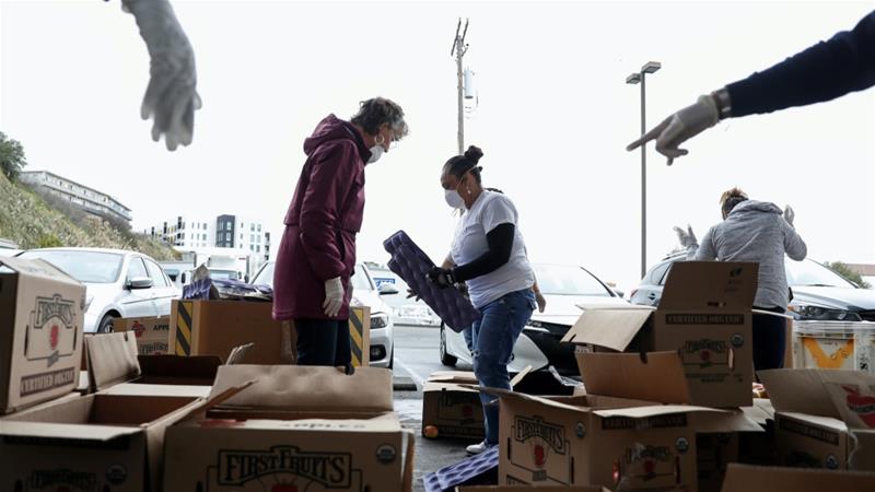 Volunteers sort apples at the San Francisco Marin Food Bank amid the novel coronavirus COVID 19 outbreak in San Francisco California US March 16 2020