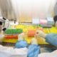 Workers in protective suits examine specimens inside a laboratory following an outbreak of the novel coronavirus in Wuhan China on February 6 2020