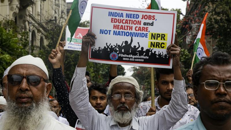 An Indian Muslim protester holds up a poster during a demonstration against the Citizenship Amendment Act