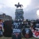 Black Lives Matter protesters wait for police action as they surround the statue of Confederate General Robert E Lee on Monument Avenue June 23 2020 in Richmond US