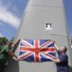 Members of far right Football Lads Alliance hold a British flag in front of the covered statue of Winston Churchill in Parliament Square London June 13 2020