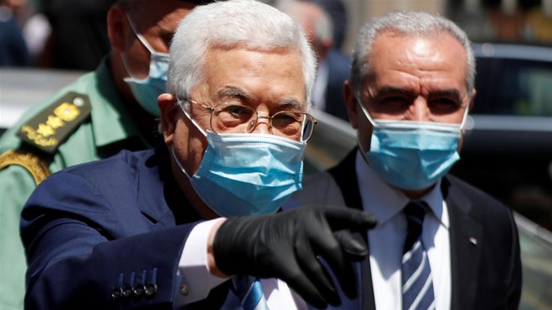 Palestinian President Mahmoud Abbas gestures as Prime Minister Mohammad Shtayyeh stands next to him during a tour in Ramallah occupied West Bank on June 15 2020