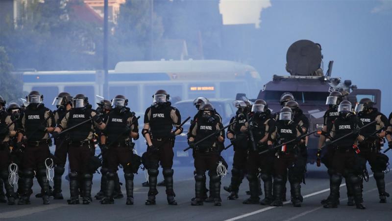 Police in riot gear prepare to advance on protesters rallying after the death of George Floyd in Minneapolis US on May 30 2020