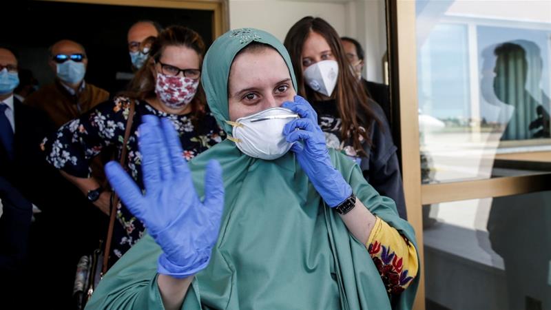 Silvia Romano an Italian aid worker who was kidnapped by gunmen in Kenya 18 months ago waves at Ciampino military airport in Rome Italy on May 10 2020