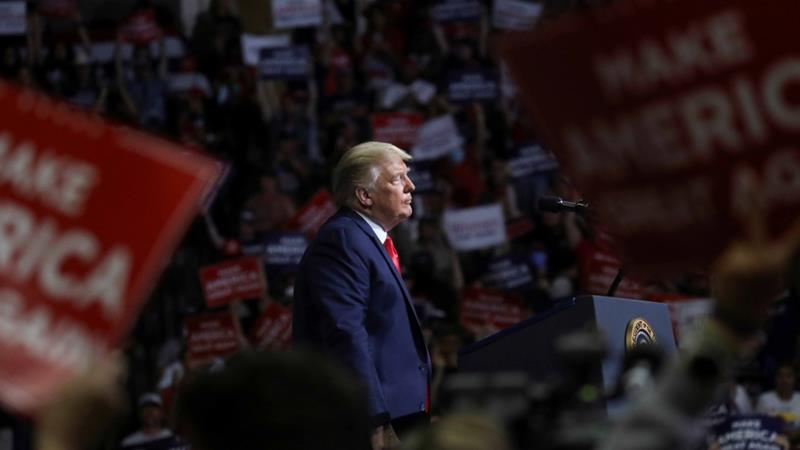 US President Donald Trump stands at the podium listening to his supporters cheer as he addresses his first campaign rally in months in Tulsa US on June 20 2020
