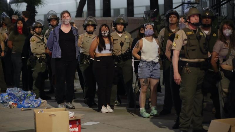 People who participated in a protest against the May 25 police killing of George Floyd are being arrested for curfew violation in downtown Los Angeles June 3 2020