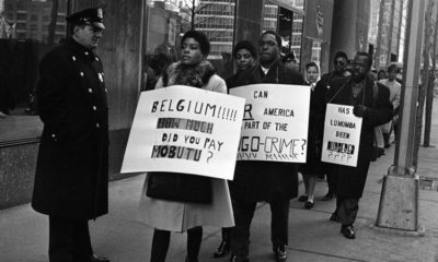 Pickets carrying anti Belgian and pro Lumumba placards parade near the Belgian consulate in New York on February 11 1961