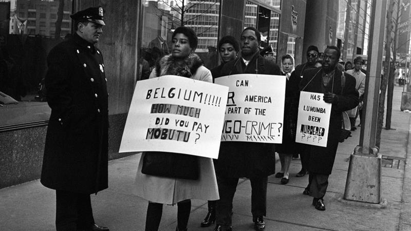 Pickets carrying anti Belgian and pro Lumumba placards parade near the Belgian consulate in New York on February 11 1961