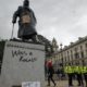 Protesters and police gather around the statue of Winston Churchill in Parliament Square during the Black Lives Matter protest rally in London Sunday June 7 2020