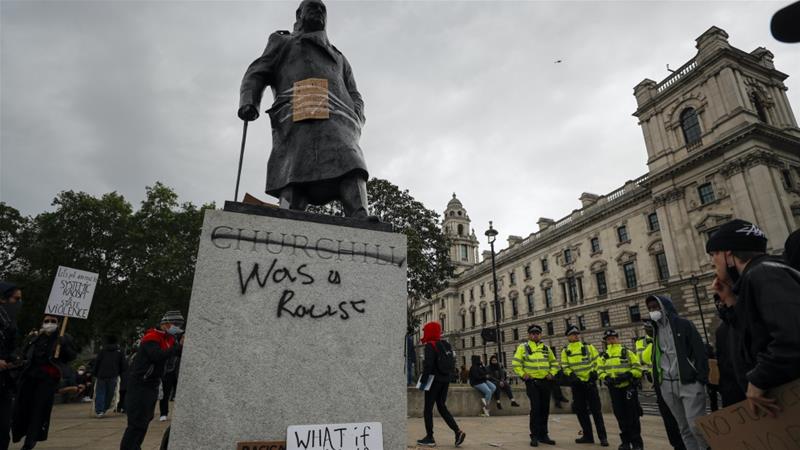 Protesters and police gather around the statue of Winston Churchill in Parliament Square during the Black Lives Matter protest rally in London Sunday June 7 2020