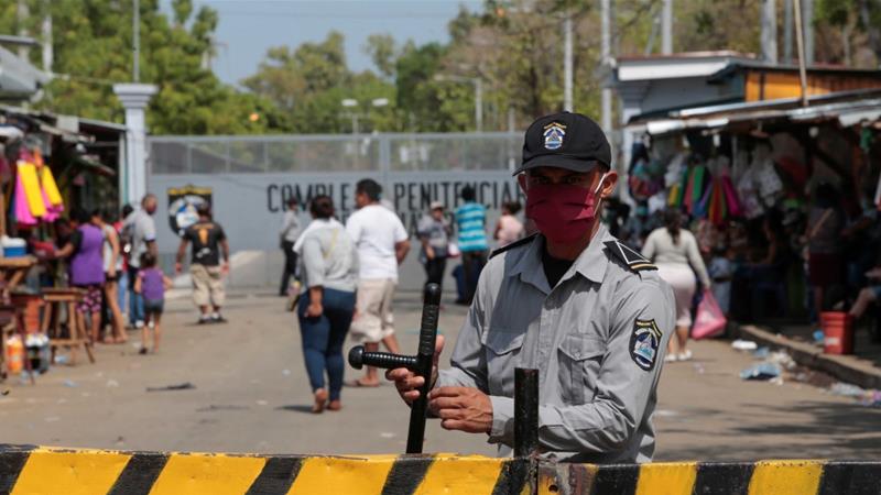 A prison guard stands at the entrance of La Modelo after 2500 prisoners were released due to coronavirus concerns in Nicaragua
