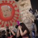 A protester holds a sign depicting Prime Minister Benjamin Netanyahu during a demonstration outside his residence in Jerusalem on July 31 2020