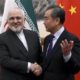 Chinas Foreign Minister Wang Yi shakes hands with his Iranian counterpart Mohammad Javad Zarif during a meeting in Beijing China on December 31 2019