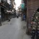 Indian security force personnel stand guard in front closed shops in a street in Srinagar October 30 2019
